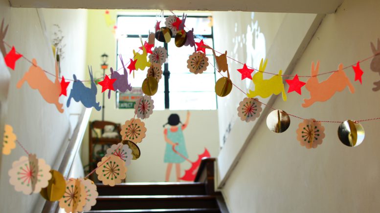 Photo of stairwell decorated with children's drawings