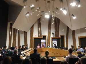 Photo of event with people sitting around a committee room table in the Scottish Parliament