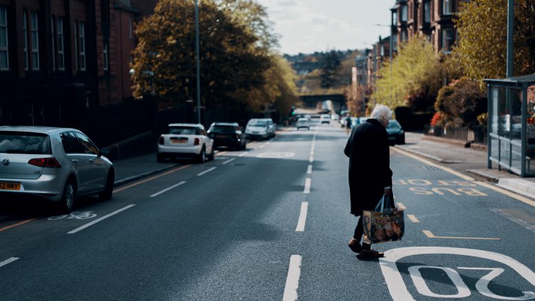 Woman crossing the road in Glasgow