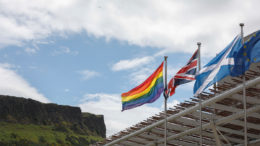 Front of Scottish Parliament building with flags flying - Pride, UK, Scotland and EU