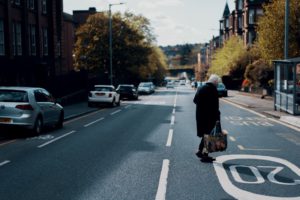 Elderly Woman Crossing city street