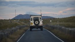 Range-rover driving into distance toward mountain