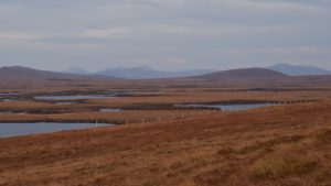 Scottish hills with moorland and water in foreground