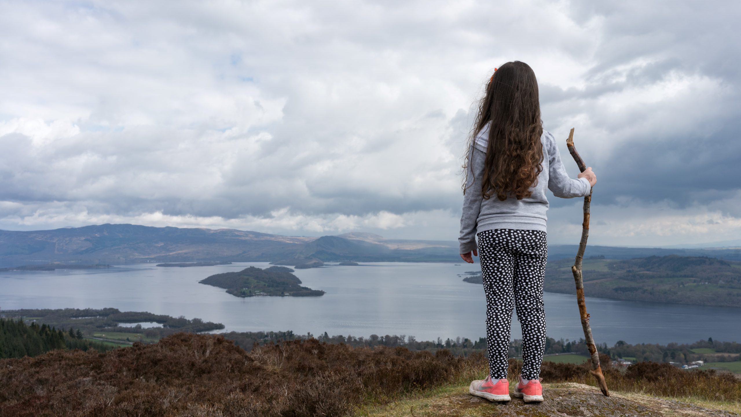 Girl looks out over loch