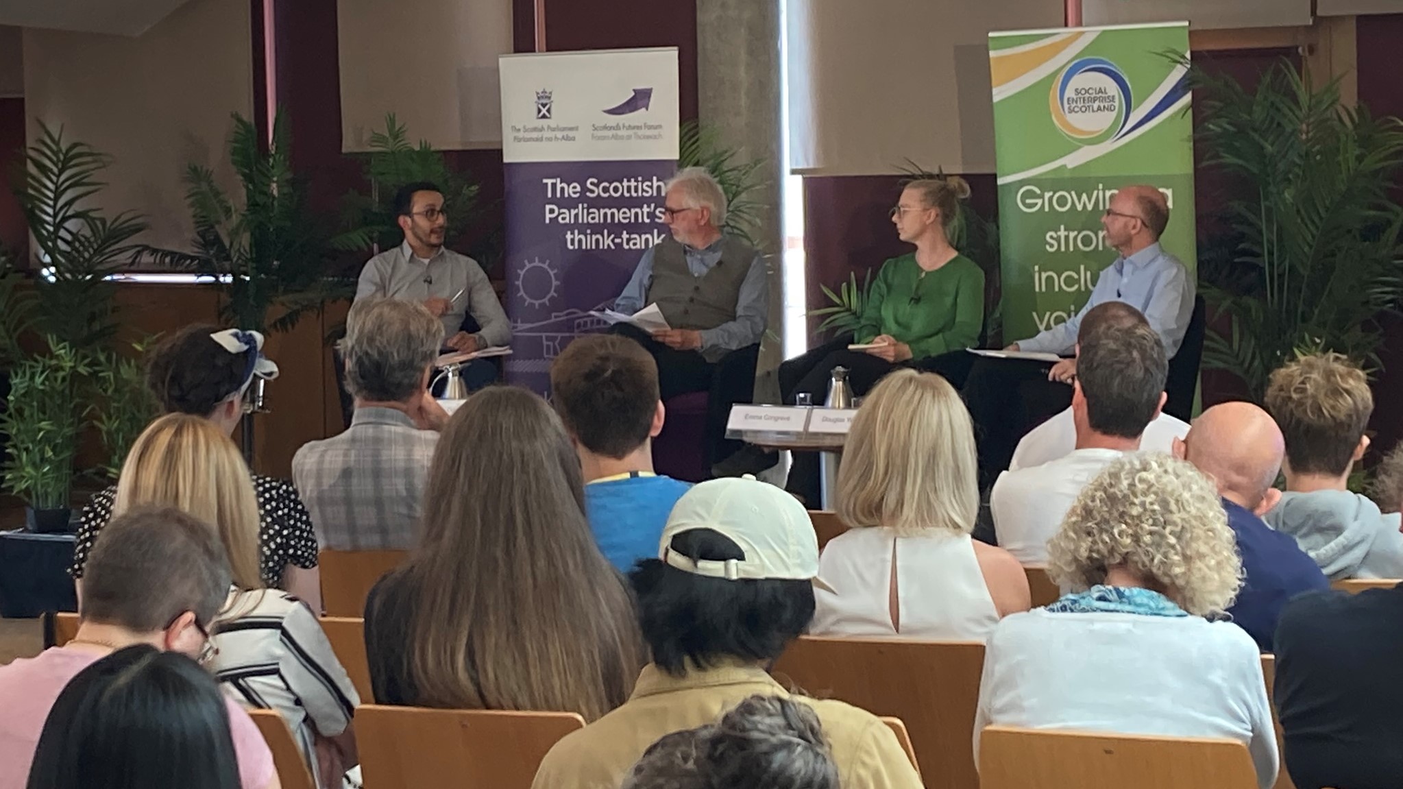 Panel of speakers in a room at the Scottish Parliament