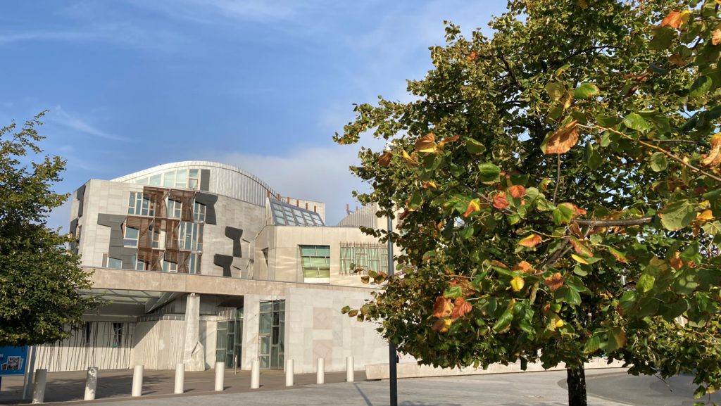 Picture of the Scottish parliament with autumnal tree in foreground